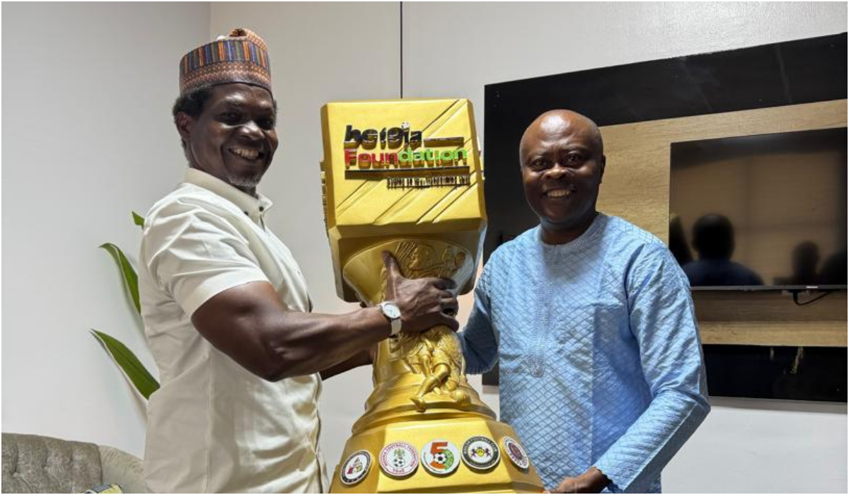 Hajji Gafar presents Ex-Internationals Cup trophy to Hon. Kunle Soname